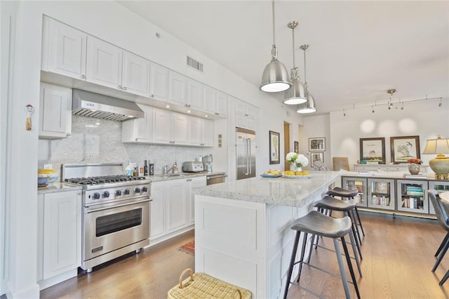 1820 Peachtree St NW Unit 1008, Atlanta, GA 30309 - kitchen with high end appliances, extractor fan, open floor plan, white cabinets, and tasteful backsplash