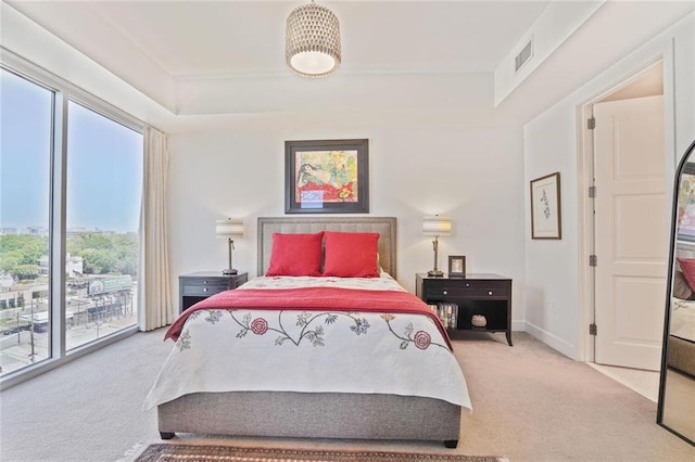 1820 Peachtree St NW Unit 1008, Atlanta, GA 30309 - carpeted bedroom featuring access to exterior, multiple windows, a raised ceiling, and baseboards