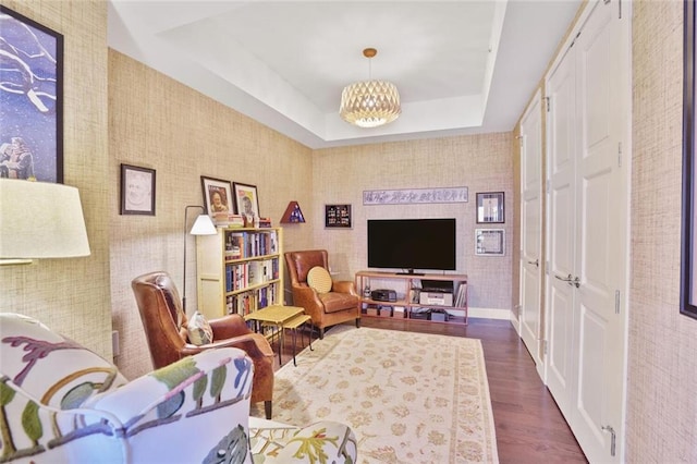 1820 Peachtree St NW Unit 1008, Atlanta, GA 30309 - living area with dark wood finished floors, a chandelier, and a raised ceiling