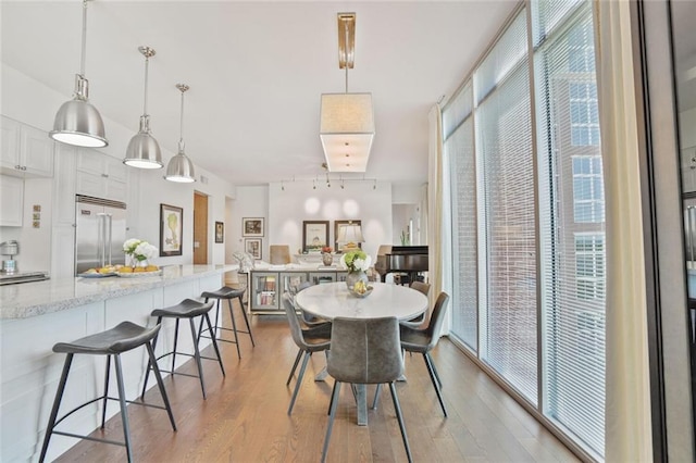 1820 Peachtree St NW Unit 1008, Atlanta, GA 30309 - dining room with wood finished floors and rail lighting