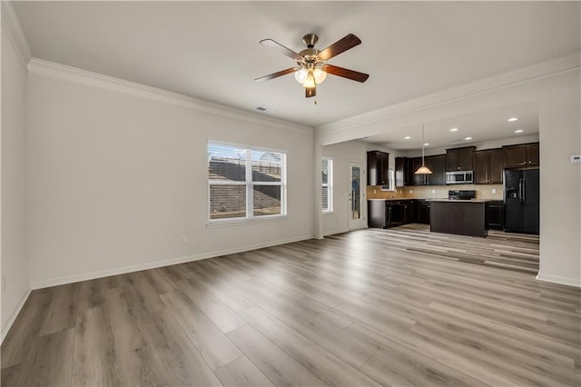 unfurnished living room with baseboards, ceiling fan, light wood-style flooring, and crown molding