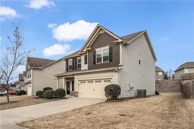 view of front of house with driveway, an attached garage, fence, and central air condition unit