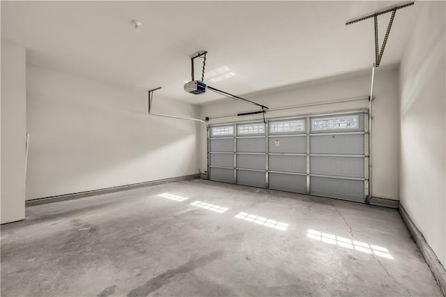 garage featuring baseboards and a garage door opener