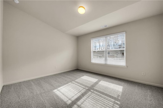 carpeted spare room with baseboards and visible vents