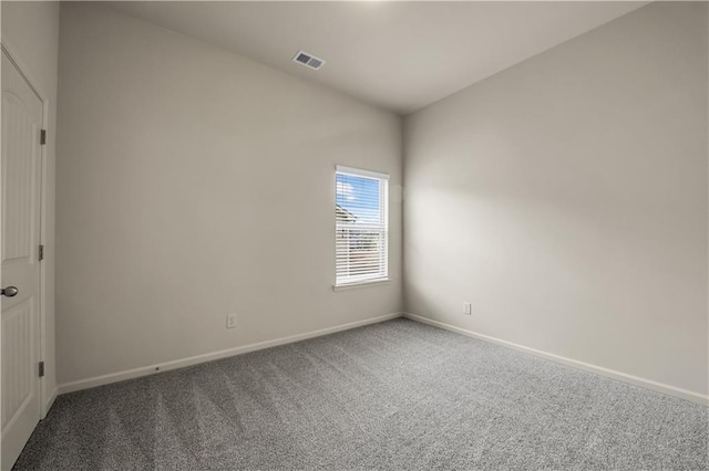 empty room featuring baseboards, visible vents, and carpet flooring