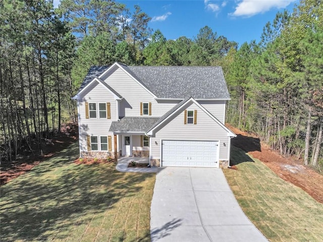 view of front of house with a front yard and a garage