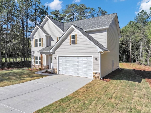 view of front property featuring a garage and a front yard