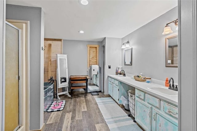 437 Crabapple Rd, Dahlonega, GA 30533 - bathroom featuring wood finished floors, double vanity, a stall shower, and recessed lighting