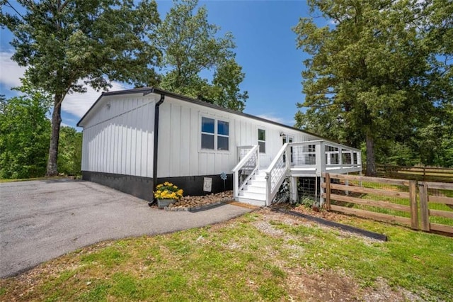 437 Crabapple Rd, Dahlonega, GA 30533 - manufactured / mobile home with board and batten siding and a deck
