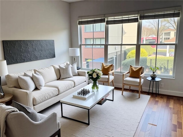 384 Ralph Mcgill Blvd NE Unit 121, Atlanta, GA 30312 - living room with wood finished floors, a healthy amount of sunlight, and baseboards