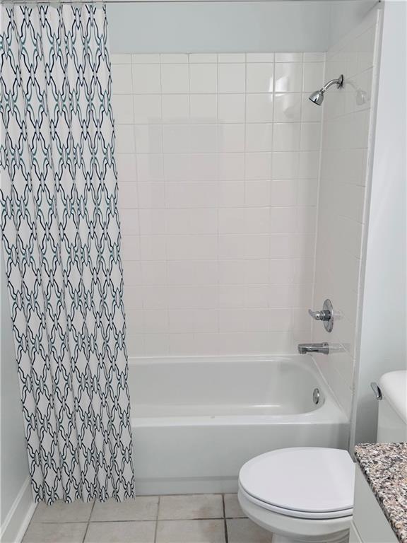 384 Ralph Mcgill Blvd NE Unit 121, Atlanta, GA 30312 - unfurnished bedroom featuring a spacious closet, baseboards, wood finished floors, and a closet