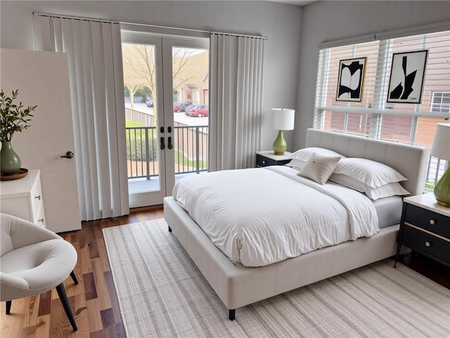 384 Ralph Mcgill Blvd NE Unit 121, Atlanta, GA 30312 - bedroom with wood finished floors, access to exterior, multiple windows, and french doors