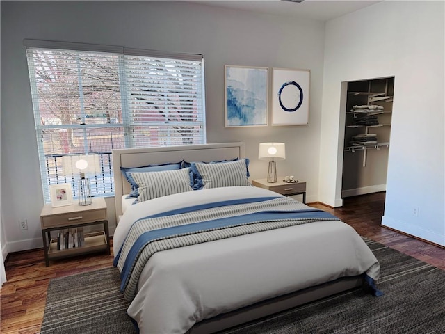 384 Ralph Mcgill Blvd NE Unit 121, Atlanta, GA 30312 - bedroom with a walk in closet, wood finished floors, a closet, and baseboards
