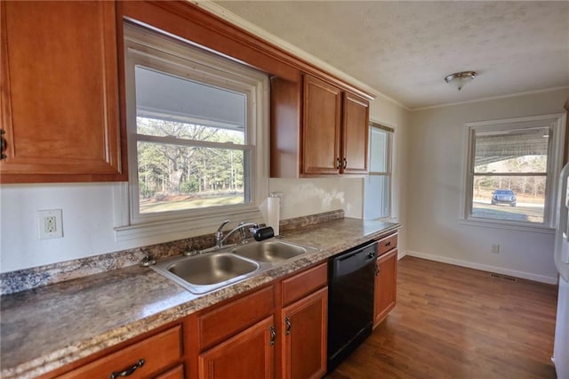 kitchen featuring dishwasher, brown cabinets, a sink, and a healthy amount of sunlight