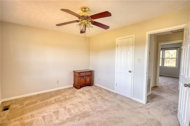 unfurnished bedroom featuring carpet flooring, visible vents, and baseboards