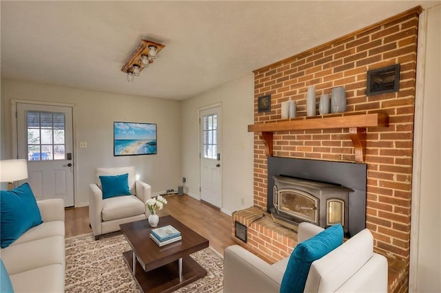 living room featuring baseboards, visible vents, and wood finished floors