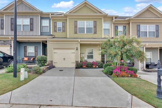 townhome / multi-family property featuring a garage and a front yard