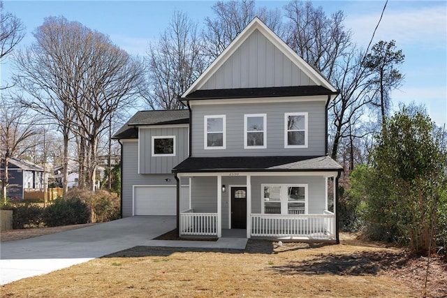 view of front of home with board and batten siding, a shingled roof, covered porch, a garage, and driveway