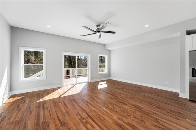 unfurnished living room with recessed lighting, baseboards, and wood finished floors