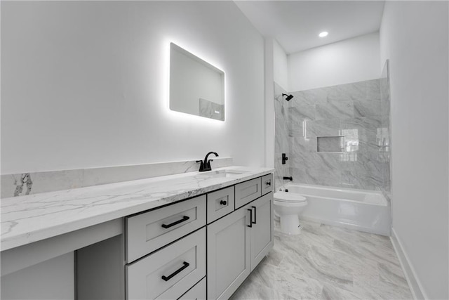 bathroom featuring toilet, marble finish floor, shower / bathing tub combination, baseboards, and vanity