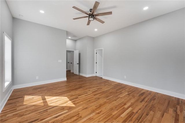 empty room featuring recessed lighting, baseboards, light wood-style floors, and a ceiling fan