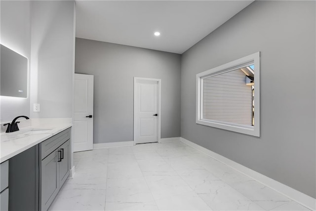 bathroom with recessed lighting, marble finish floor, vanity, and baseboards