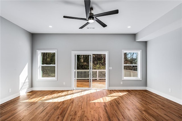 interior space with recessed lighting, plenty of natural light, wood finished floors, and baseboards