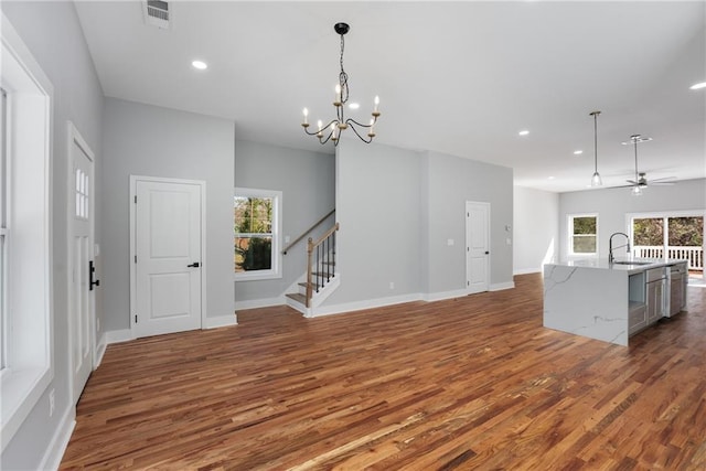 interior space featuring visible vents, a sink, stairs, and wood finished floors