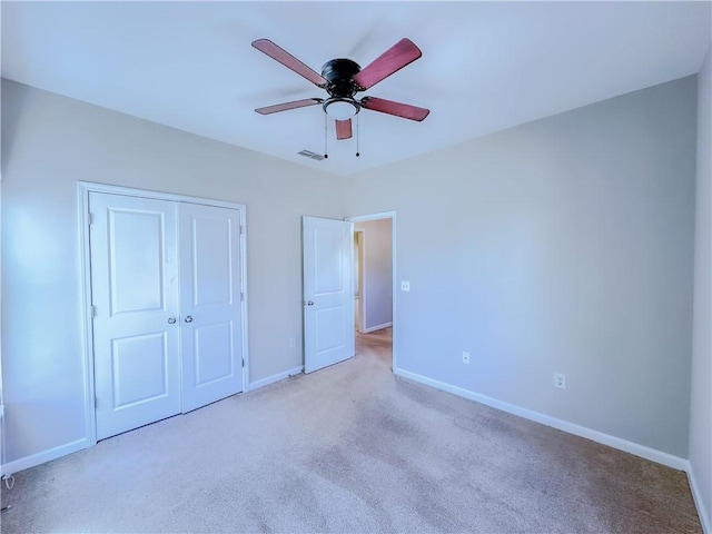 unfurnished bedroom with visible vents, baseboards, carpet floors, a closet, and a ceiling fan