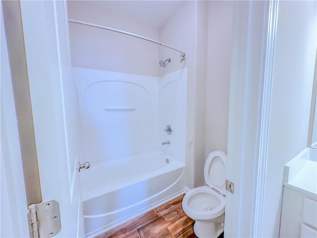 full bathroom with toilet, wood finished floors, and shower / bath combination