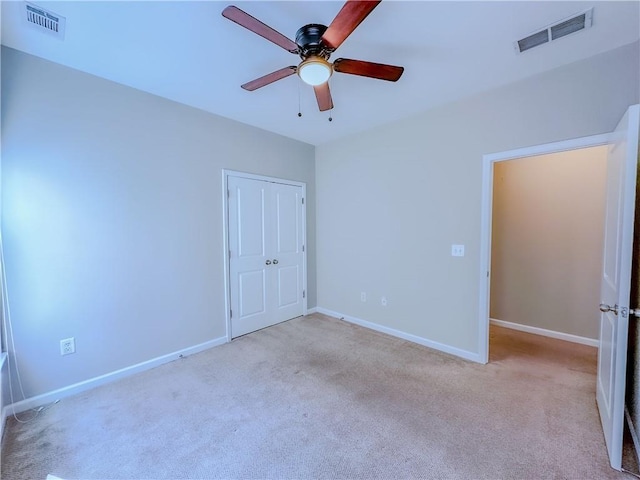 unfurnished bedroom with visible vents, baseboards, and carpet flooring