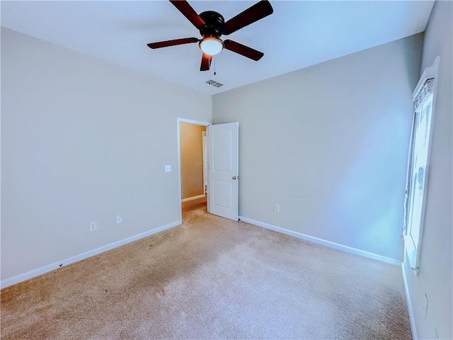 unfurnished bedroom featuring visible vents, baseboards, carpet, and a ceiling fan