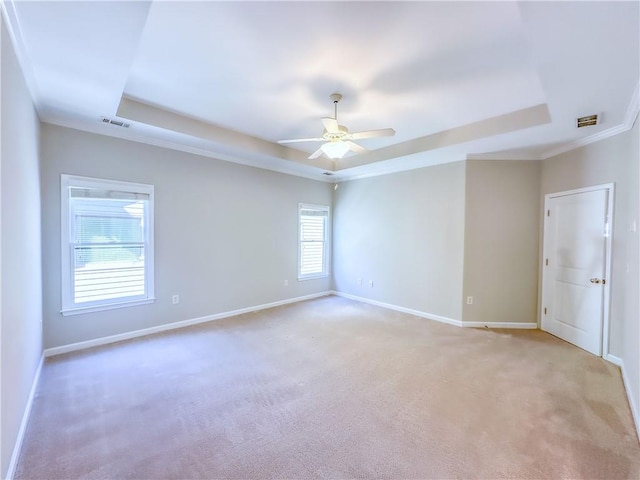 unfurnished room featuring visible vents, a raised ceiling, baseboards, and ceiling fan