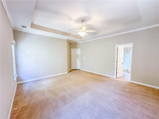 empty room with visible vents, baseboards, ornamental molding, and a ceiling fan