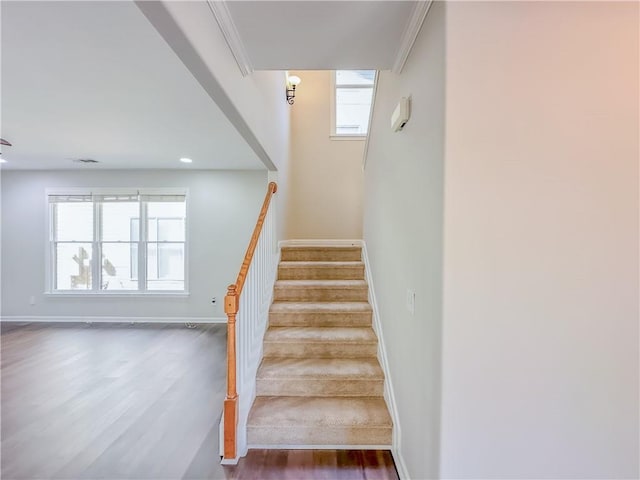 staircase featuring recessed lighting, ornamental molding, baseboards, and wood finished floors