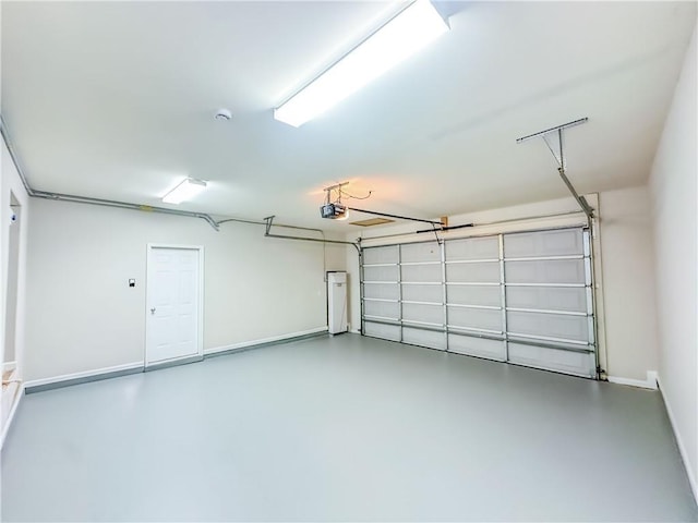 garage with a garage door opener and baseboards