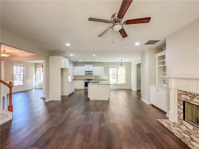 3780 Baxley Pine Trl, Suwanee, GA 30024 - unfurnished living room with dark wood-type flooring, ceiling fan, plenty of natural light, a fireplace, and recessed lighting
