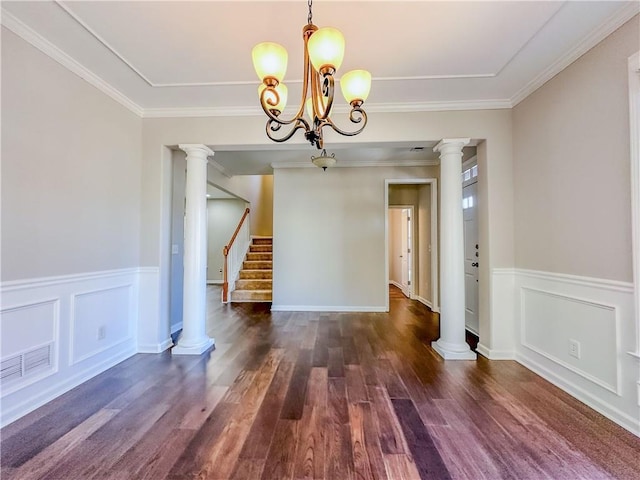 unfurnished dining area with visible vents, stairway, a wainscoted wall, wood finished floors, and a notable chandelier