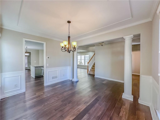 unfurnished dining area with dark wood finished floors, an inviting chandelier, ornamental molding, and wainscoting