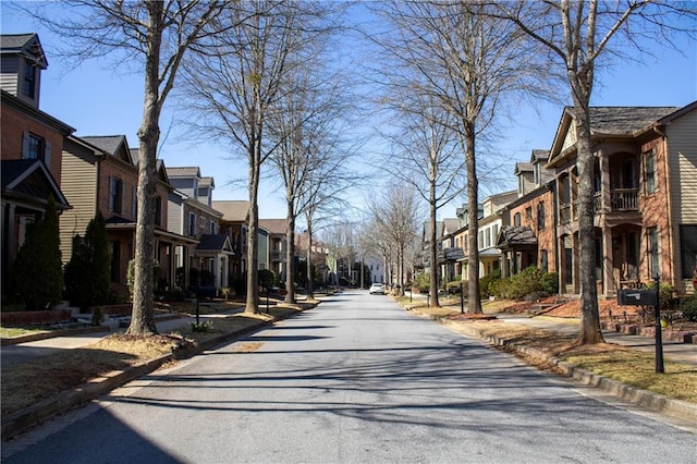 view of road with curbs, a residential view, and sidewalks