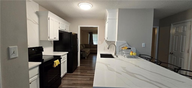 kitchen featuring white cabinetry, sink, dark hardwood / wood-style floors, range with electric cooktop, and a textured ceiling