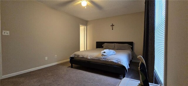 bedroom with a textured ceiling, carpet, and ceiling fan