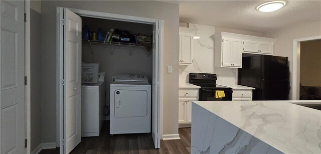 laundry area featuring dark hardwood / wood-style flooring and washer and dryer