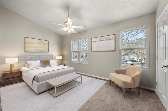 carpeted bedroom with multiple windows, a textured ceiling, baseboards, and vaulted ceiling