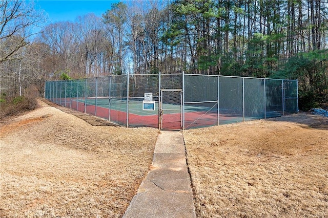 view of tennis court featuring fence