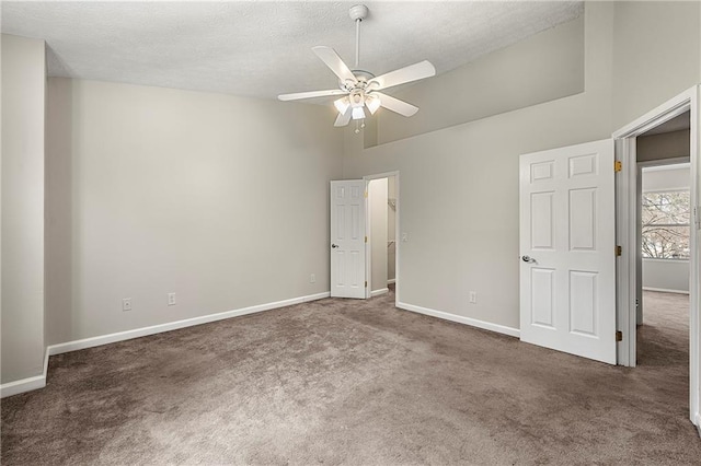 unfurnished bedroom featuring baseboards, carpet floors, and high vaulted ceiling