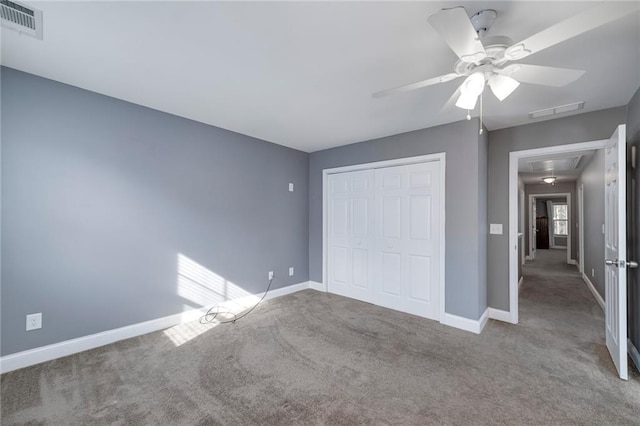 unfurnished bedroom featuring ceiling fan, carpet floors, and a closet