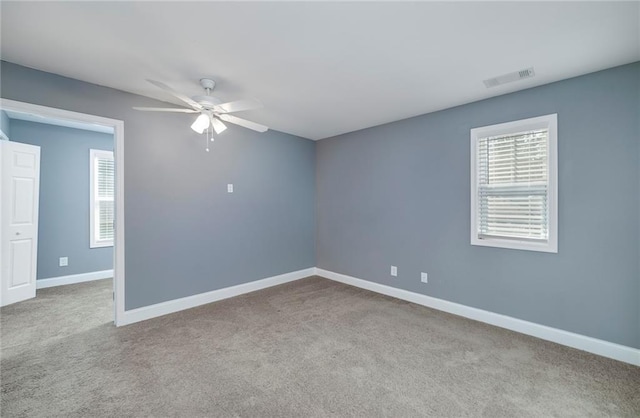 carpeted empty room featuring ceiling fan