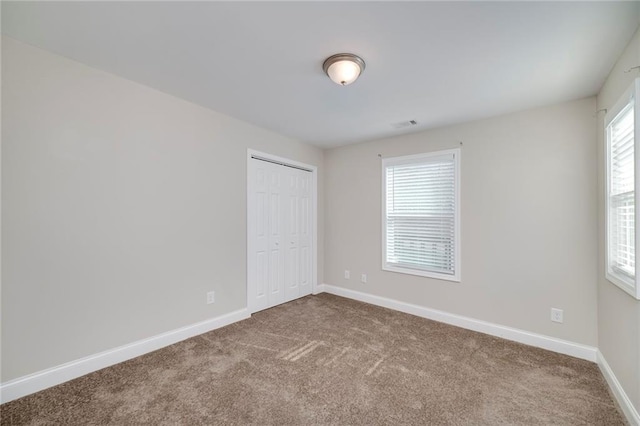 unfurnished bedroom with carpet floors and a closet