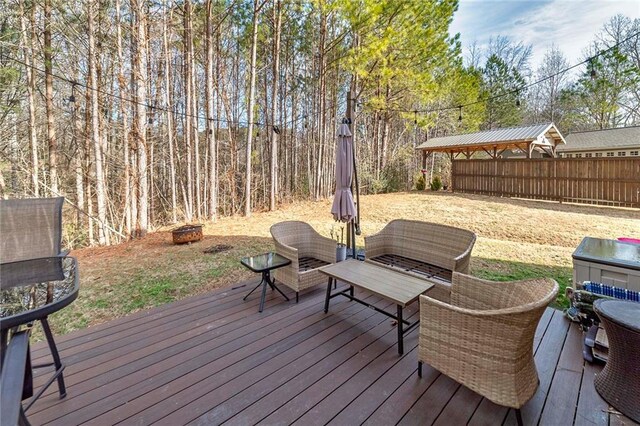 wooden deck with an outdoor fire pit